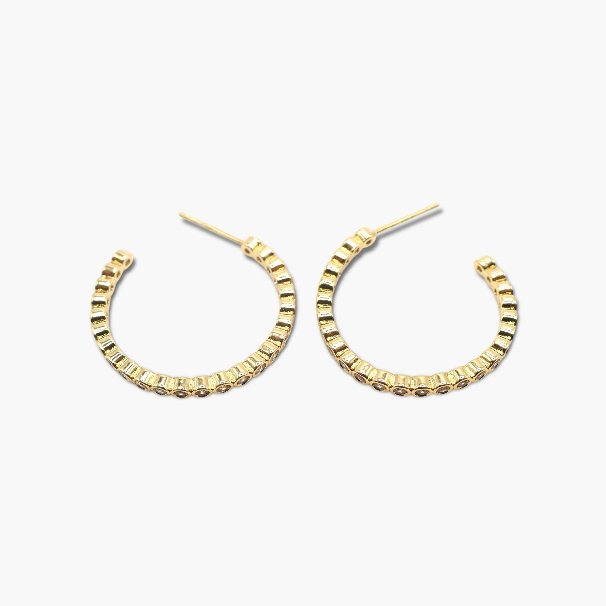 A pair of gold-dipped cubic zirconia hoop earrings with open hoops.