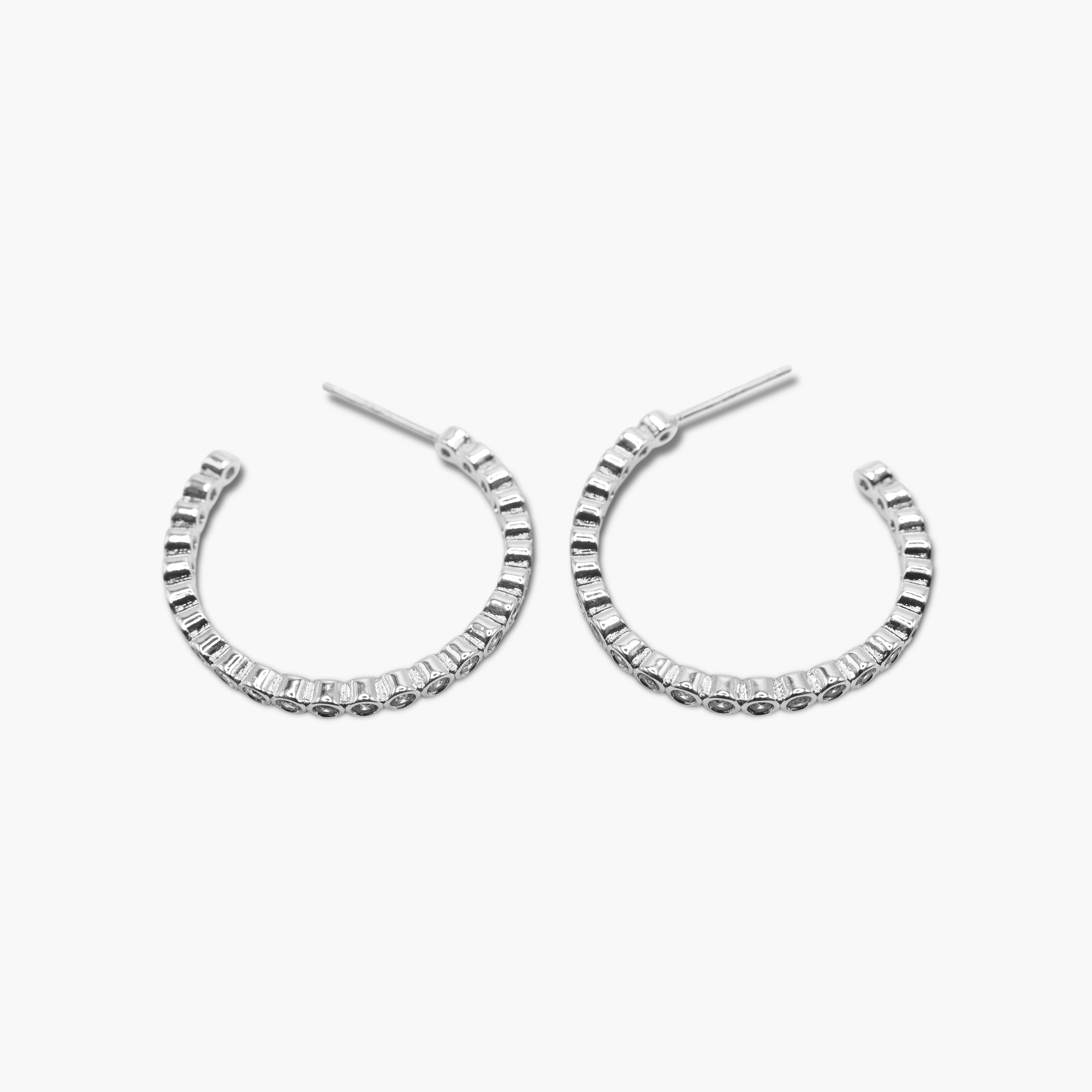 A pair of gold-dipped cubic zirconia hoop earrings with open hoops.
