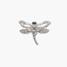 Decorative dragonfly brooch with gemstones on a white background