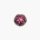 Pink gemstone brooch with black metal setting on a white background
