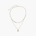 A gold necklace on a white background