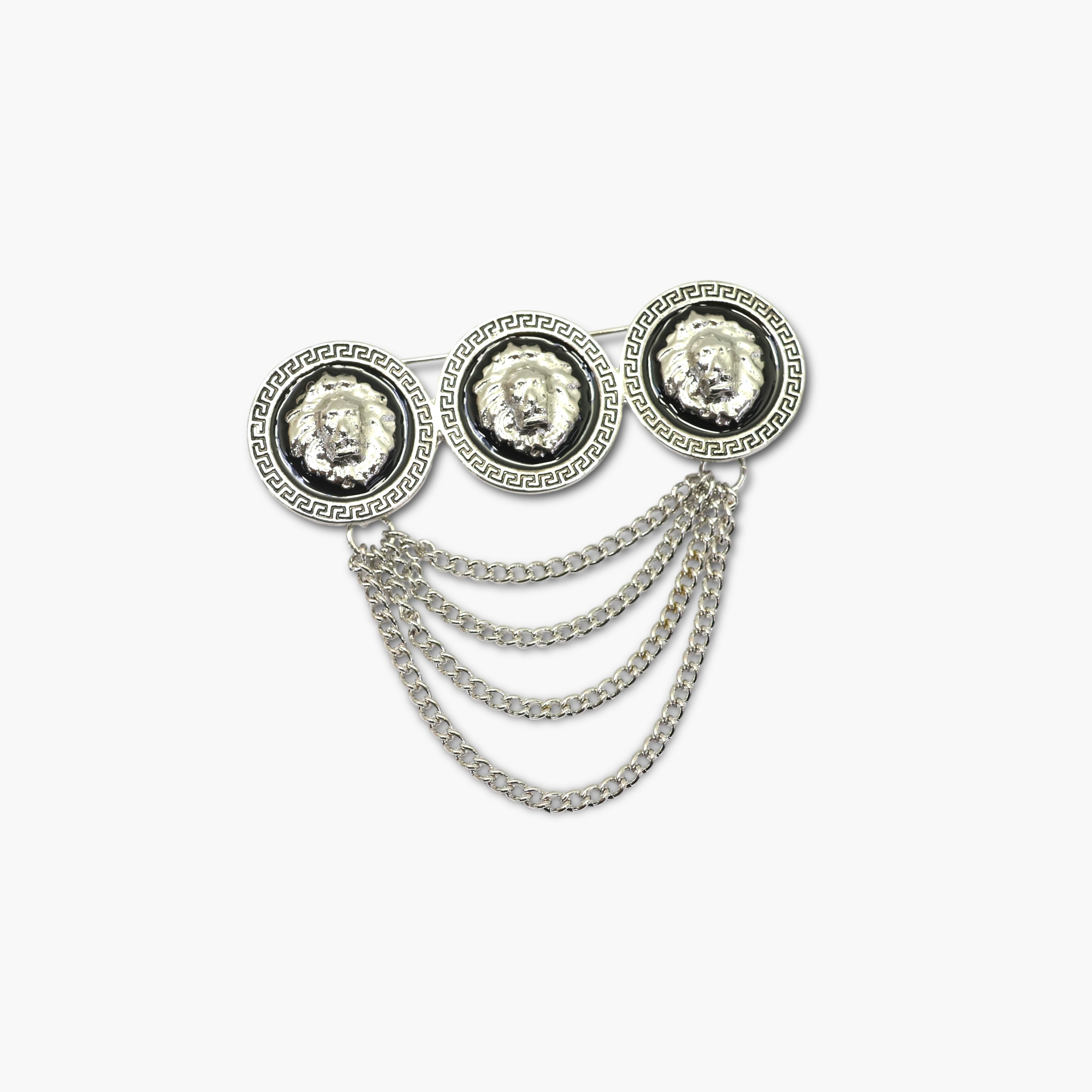 Decorative brooch with lion head designs and chain details on a white background