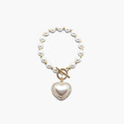 Pearl necklace with a heart-shaped pendant on a white background