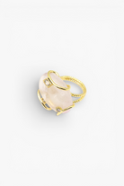 Natural stone statement ring with crystal accents in a gold-tone setting featuring an organic gemstone centerpiece.