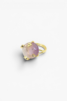 Natural stone statement ring with crystal accents in a gold-tone setting featuring an organic gemstone centerpiece.