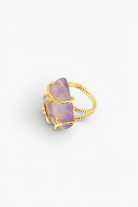 Natural stone statement ring with crystal accents in a gold-tone setting featuring an organic gemstone centerpiece.