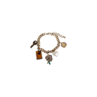 Gold charm bracelet with various charms on a white background