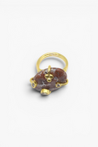 Natural stone statement ring with crystal accents in a gold-tone setting featuring an organic gemstone design.