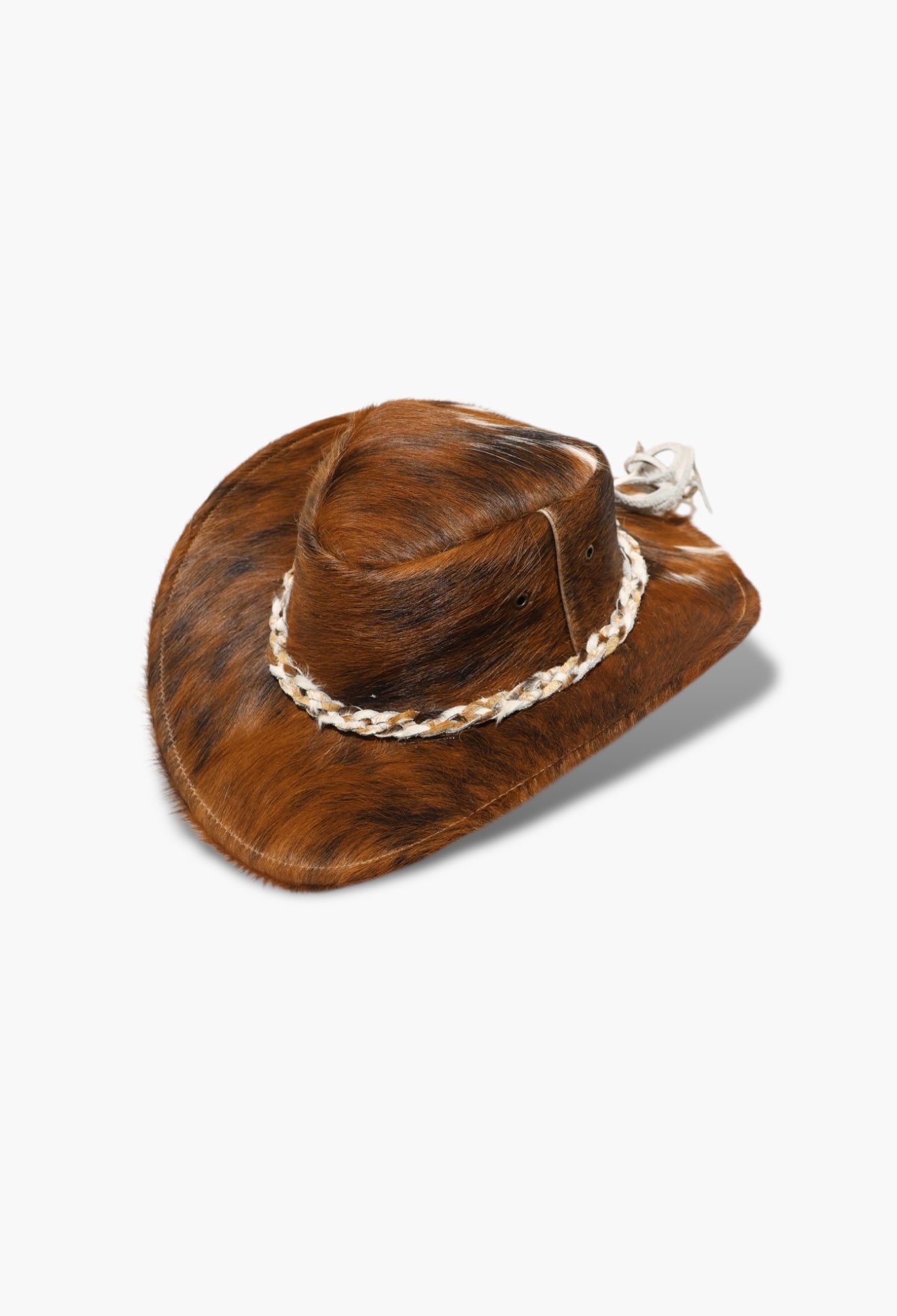 Brown cowhide cowboy hat with braided band on a white background