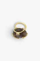 Polished natural stone statement ring with crystal accents in a textured gold-tone setting.
