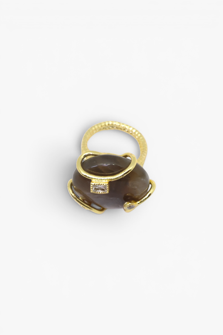 Polished natural stone statement ring with crystal accents in a textured gold-tone setting.