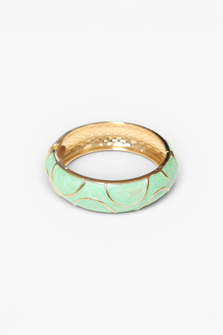 Green ring with gold accents on a white background