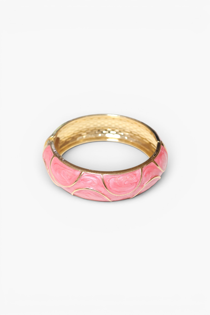 Gold and pink ring on a white background