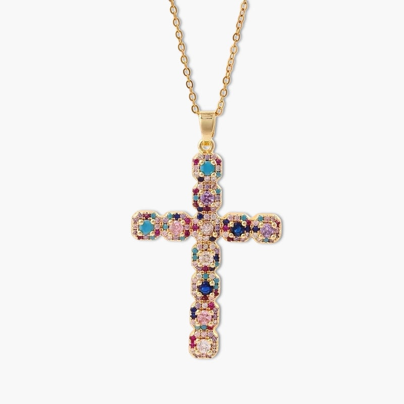 A gold-colored cross necklace pendant adorned with multicolored stones
