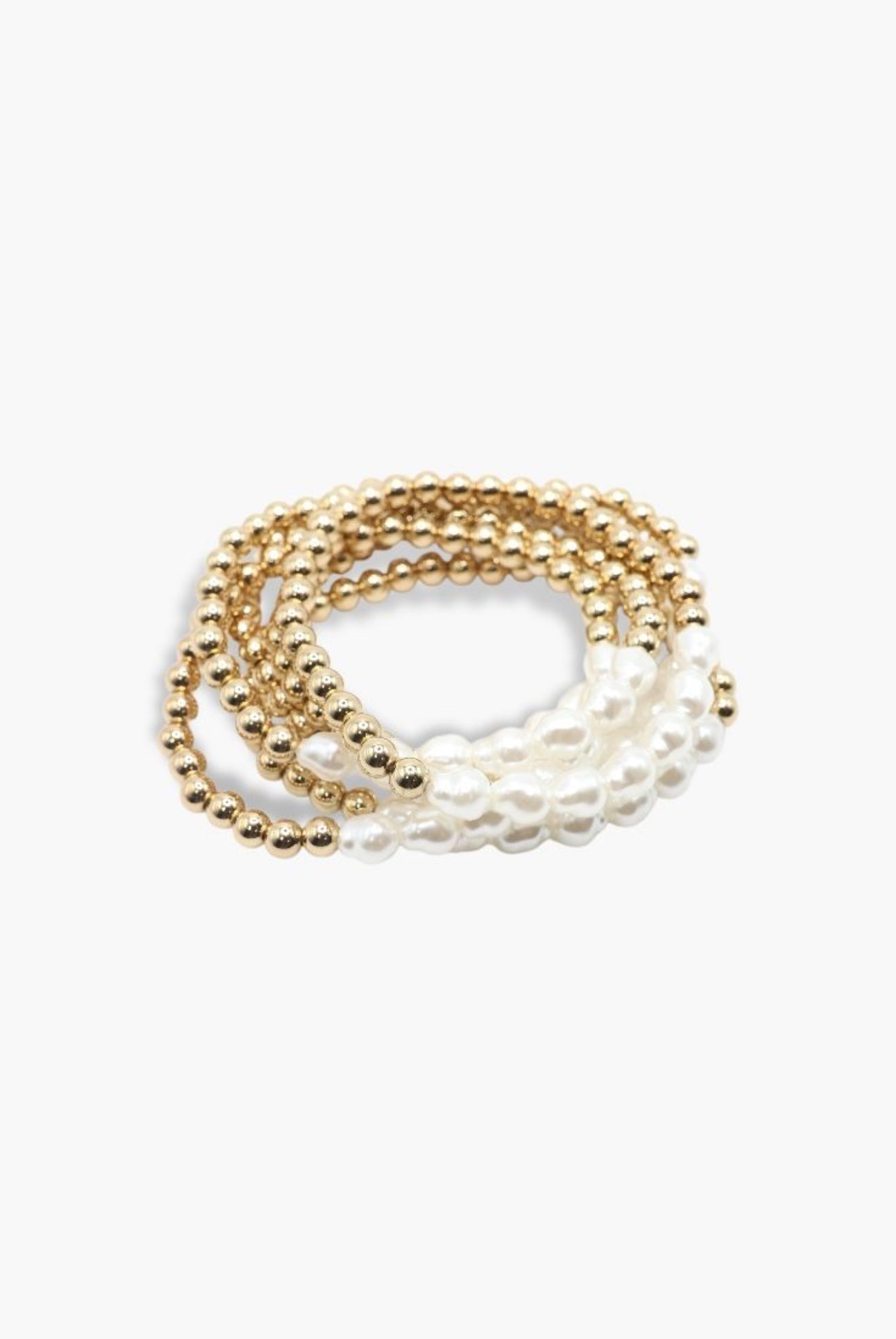 Set of gold and pearl bracelets on a white background