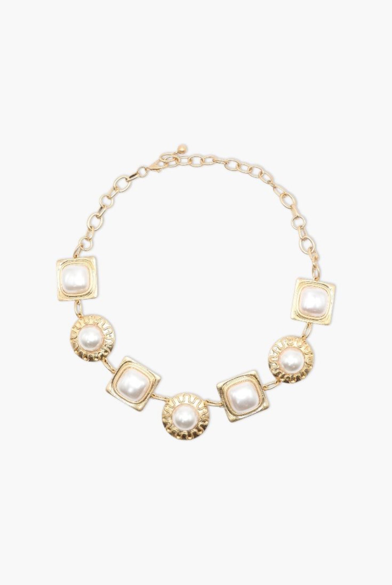 Gold necklace with square and round pendants on a white background