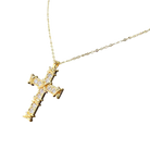 Gold cross necklace with diamonds on a white background
