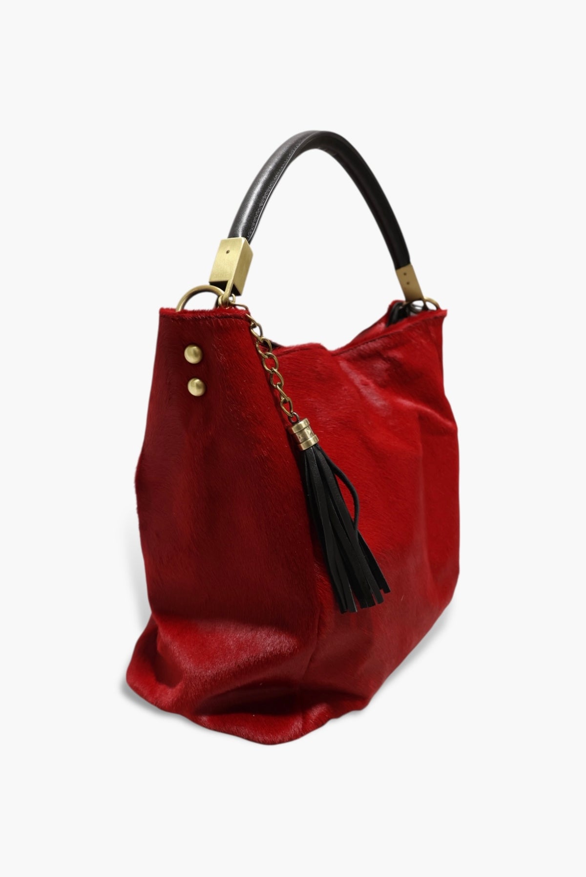 Red handbag with black handle and tassel on a white background