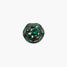 Jewelry brooch with green gemstones on a white background