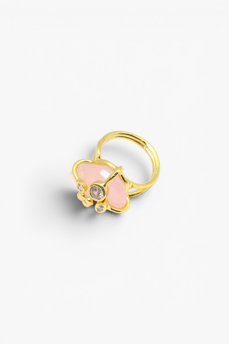 Faceted natural stone statement ring with crystal accents in a gold-tone setting featuring an elegant gemstone centerpiece.