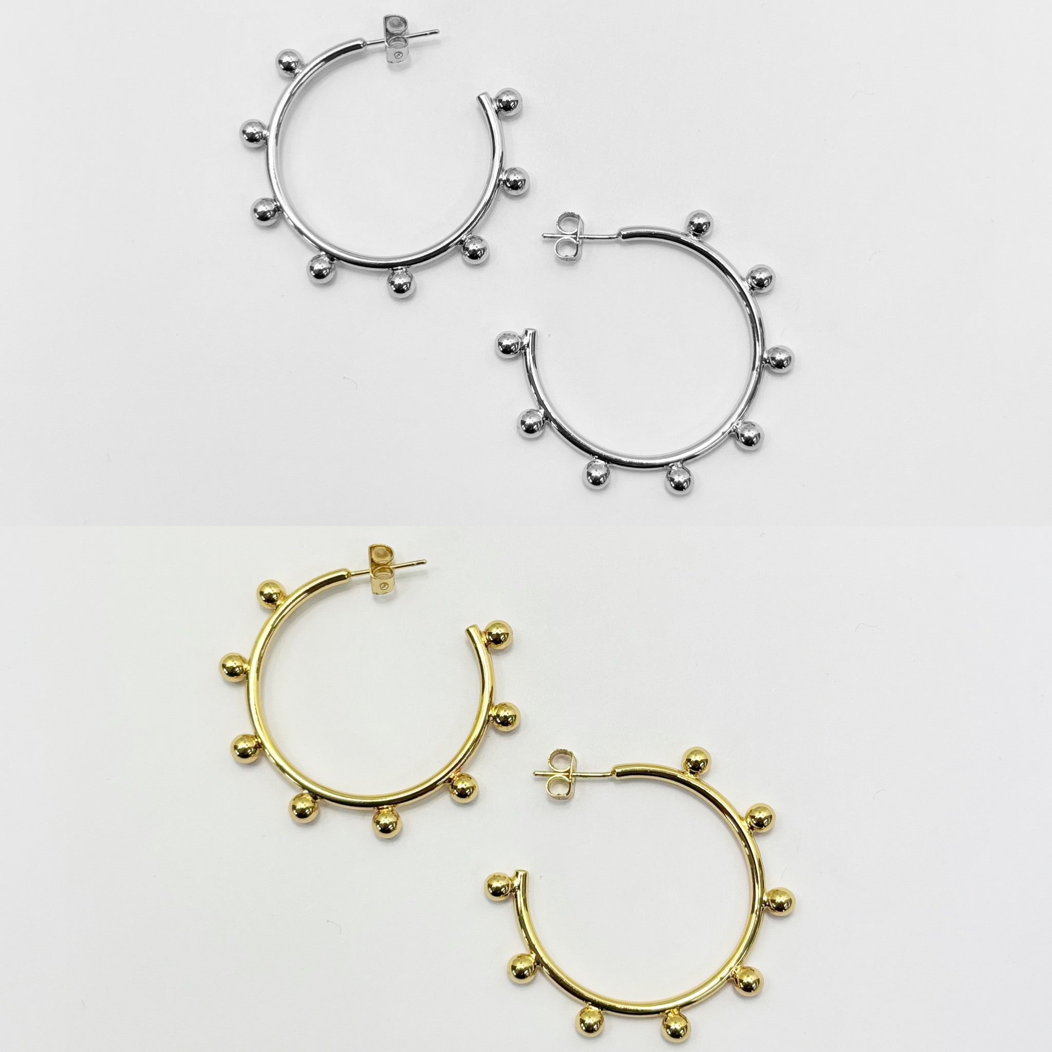 A set of three hoop earrings with silver and gold color options, featuring a hypoallergic 925 silver post.