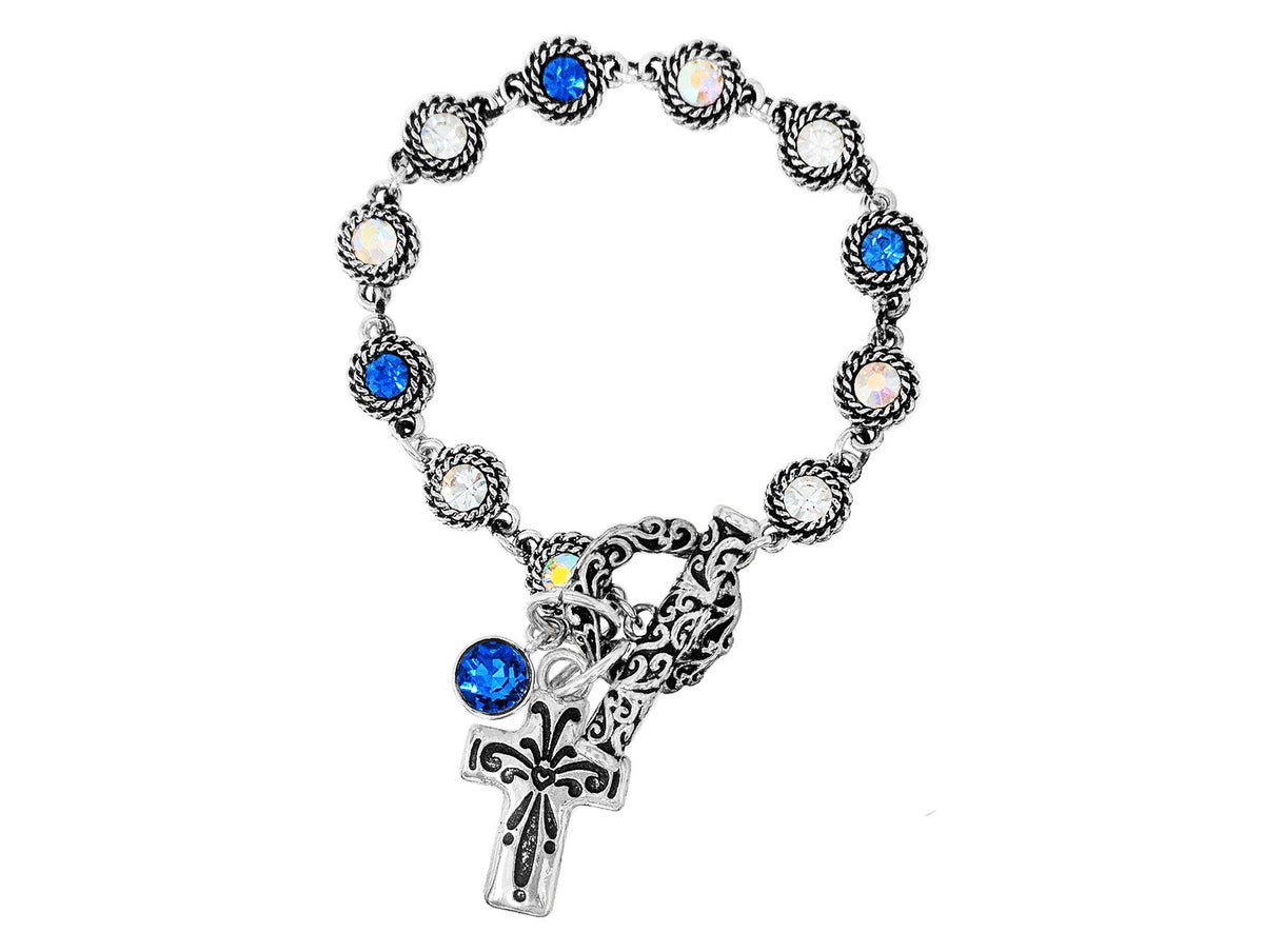 Bracelet with blue gemstones and a cross charm on a white background