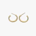 A pair of gold-colored hoop earrings with cubic zirconia accents.