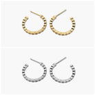 A pair of gold-colored hoop earrings with open hoops and multiple row patterns, and a pair of silver-colored hoop earrings with open hoops and multiple row patterns.