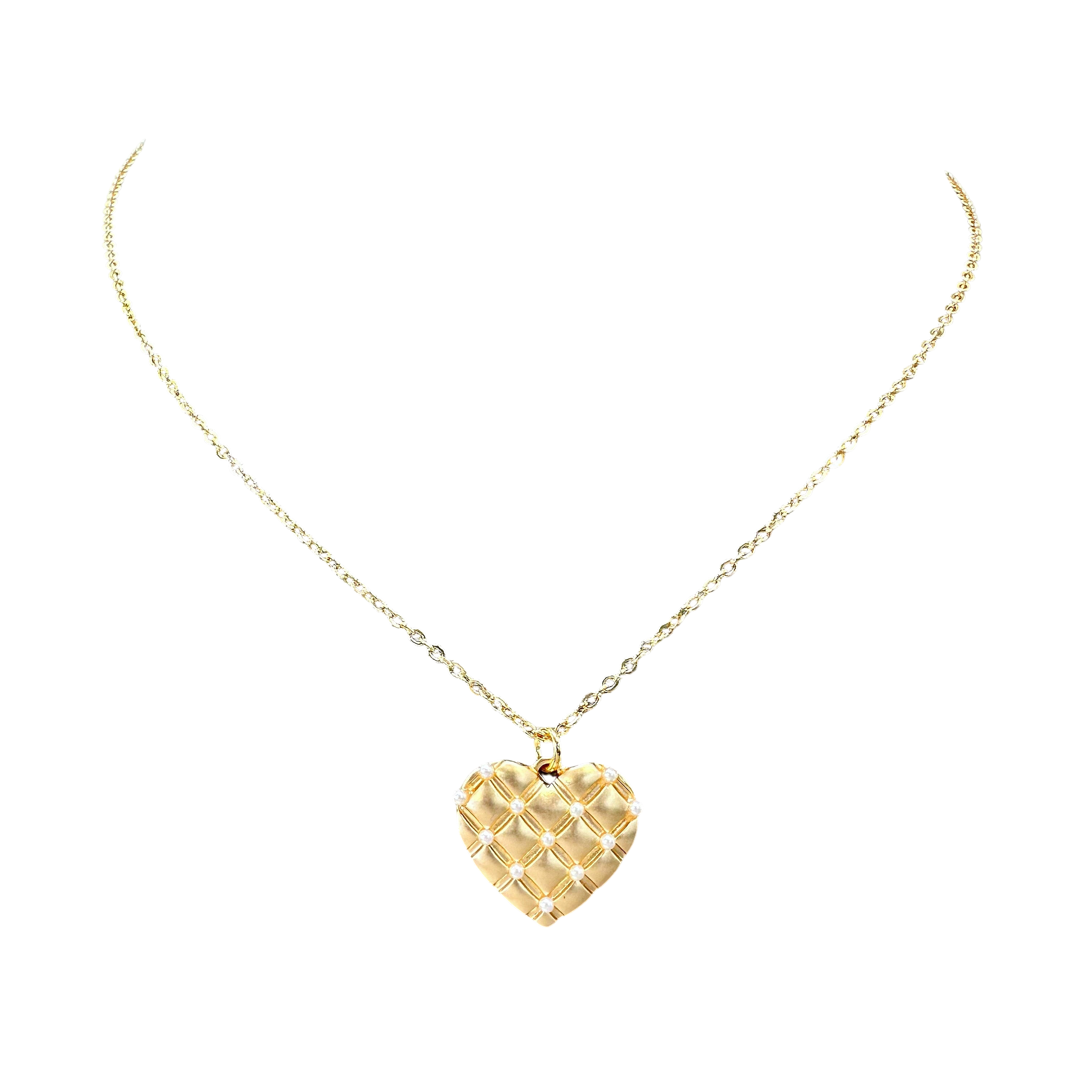 Gold heart-shaped pendant necklace on a white background