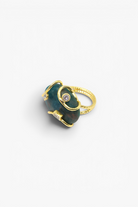 Natural stone statement ring with crystal accents in a gold-tone setting featuring an organic gemstone centerpiece.