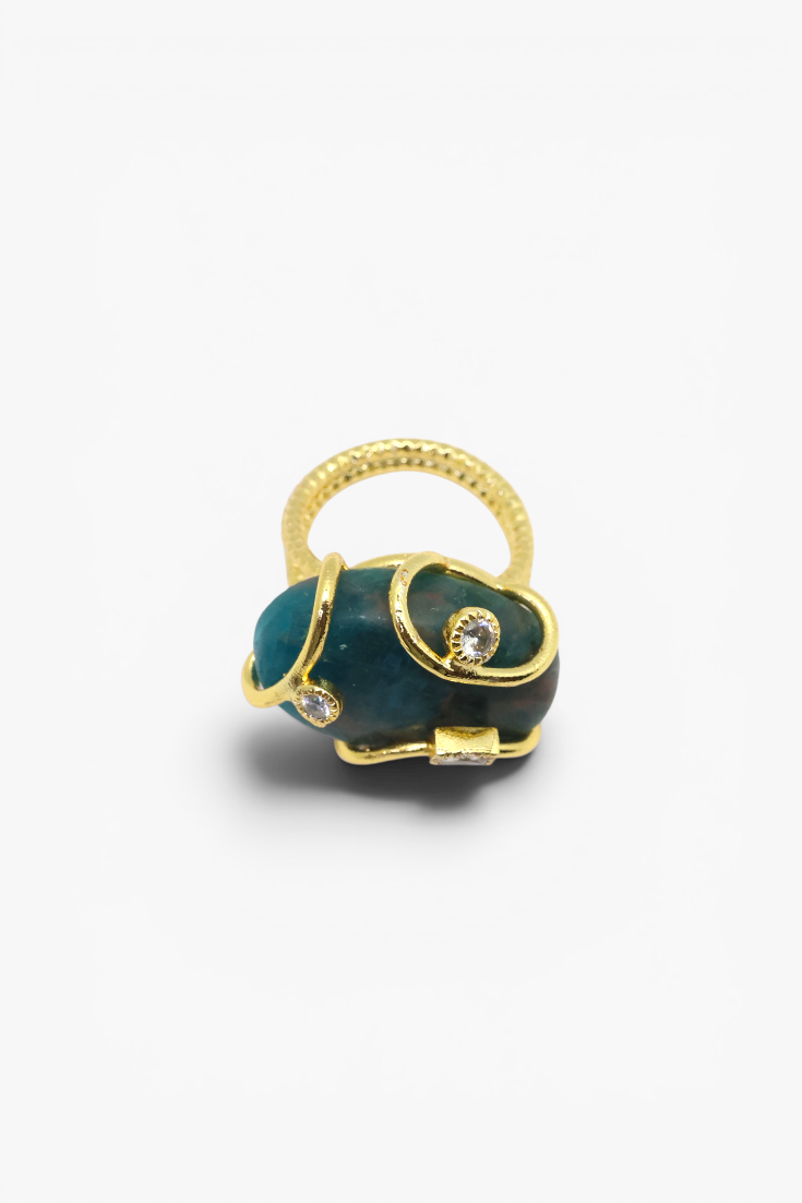 Natural stone statement ring with crystal accents in a gold-tone setting featuring an organic gemstone centerpiece.