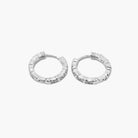 A pair of silver-colored hoop earrings with a textured surface on a white background.