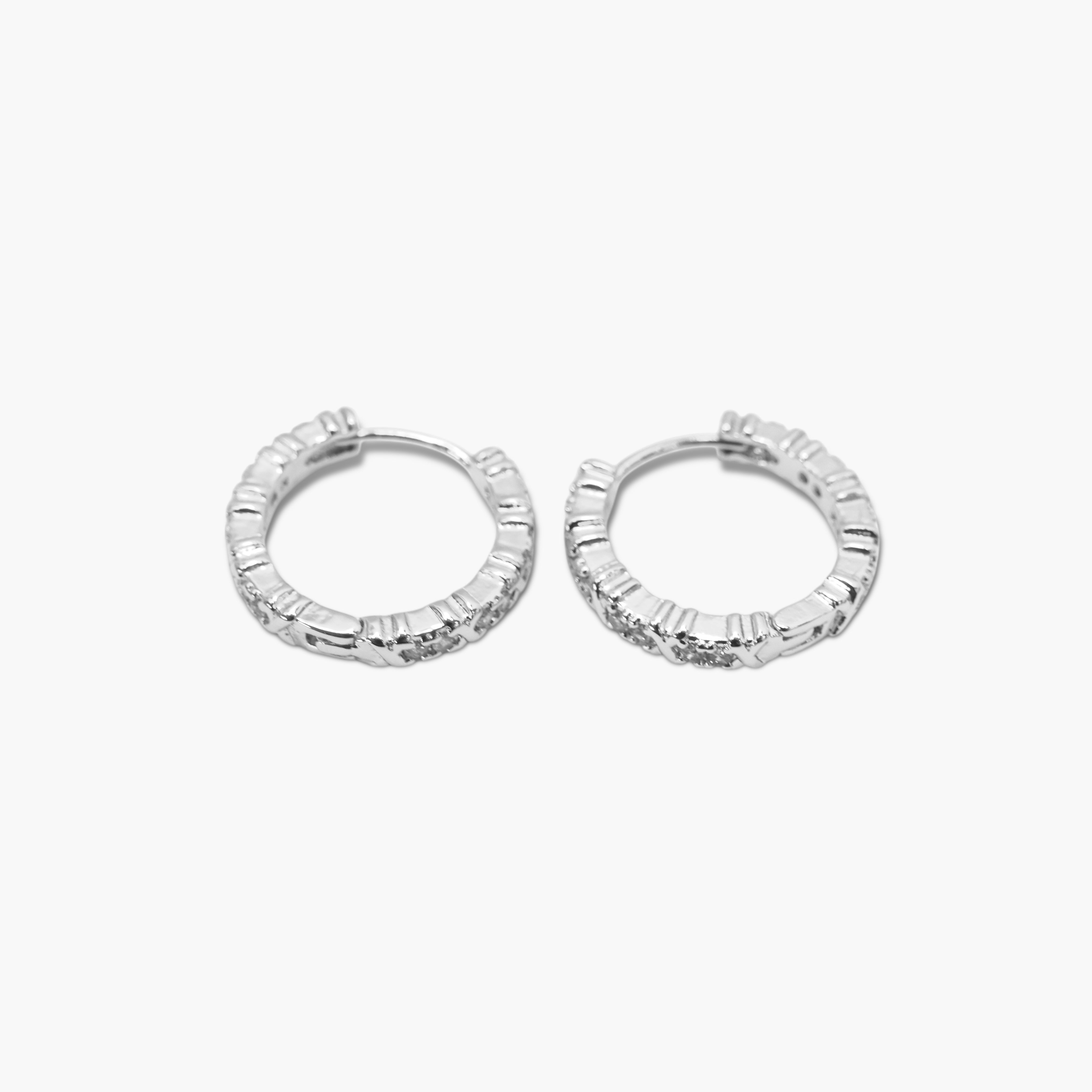 A pair of silver-colored hoop earrings with a textured surface on a white background.