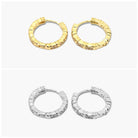 A pair of hoop earrings with a textured surface on a white background.