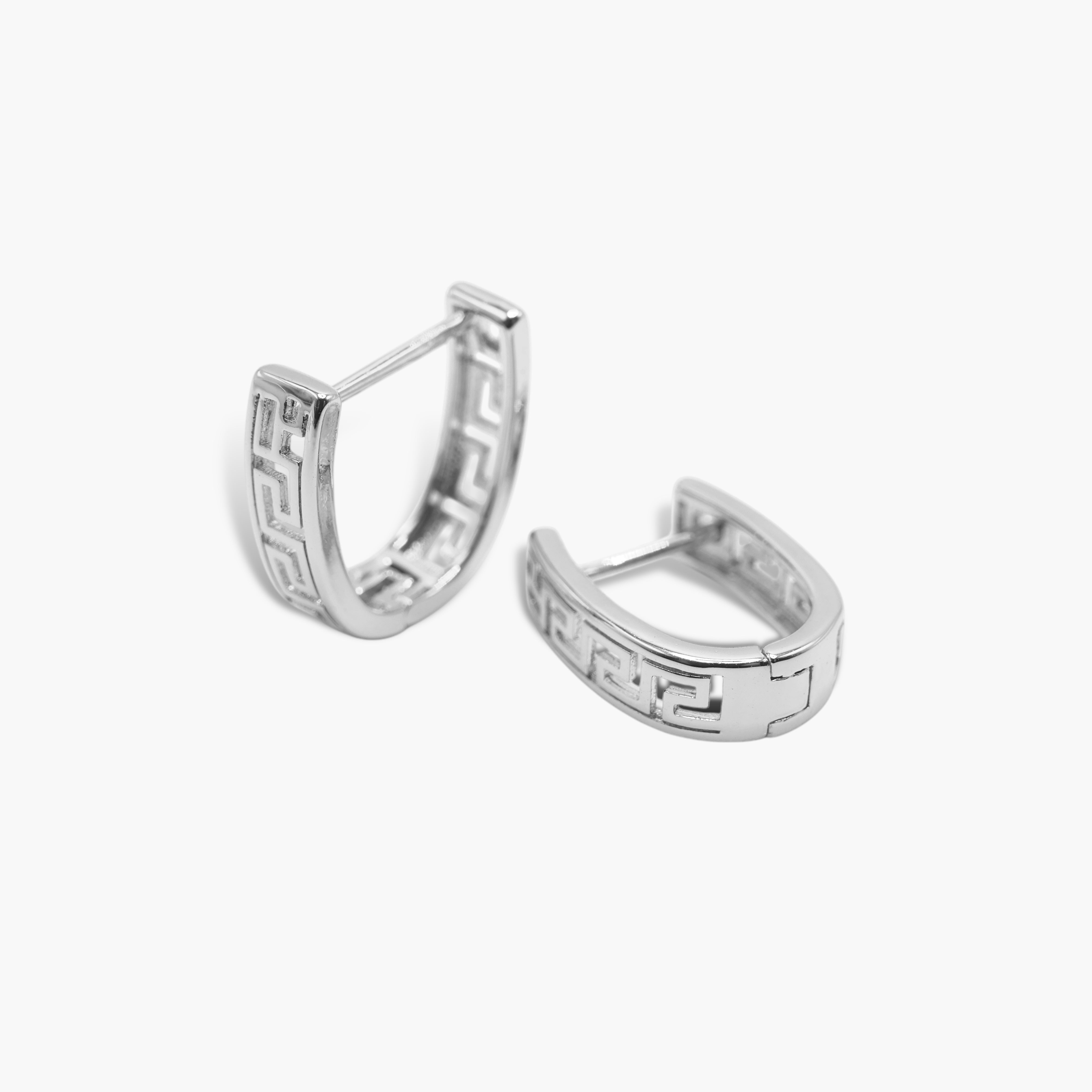 A pair of gold-colored hoop earrings with a geometric pattern on the U-shaped hoop.