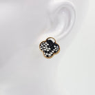 A collection of vintage style earrings with various patterns including floral, geometric, and animal prints.