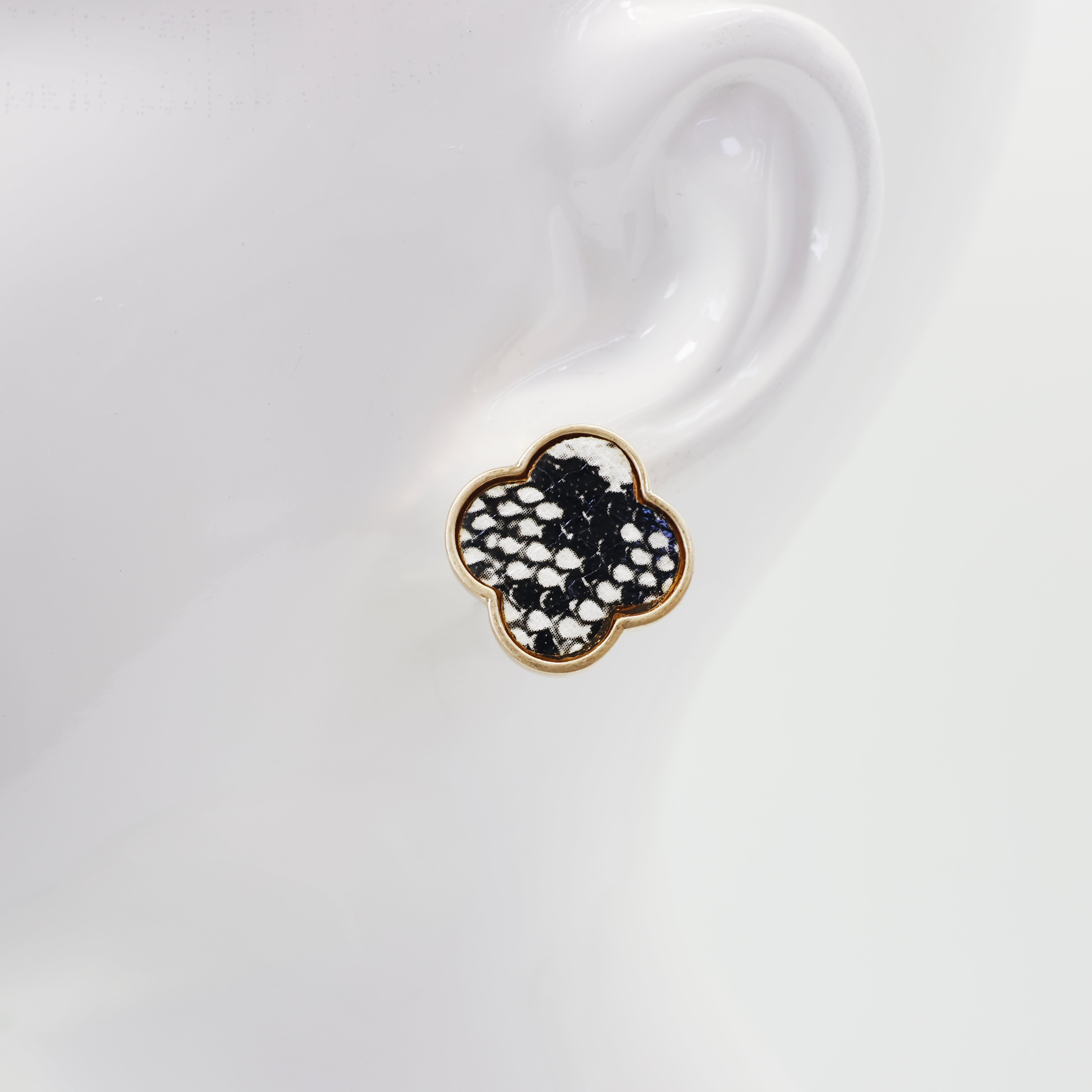 A collection of vintage style earrings with various patterns including floral, geometric, and animal prints.