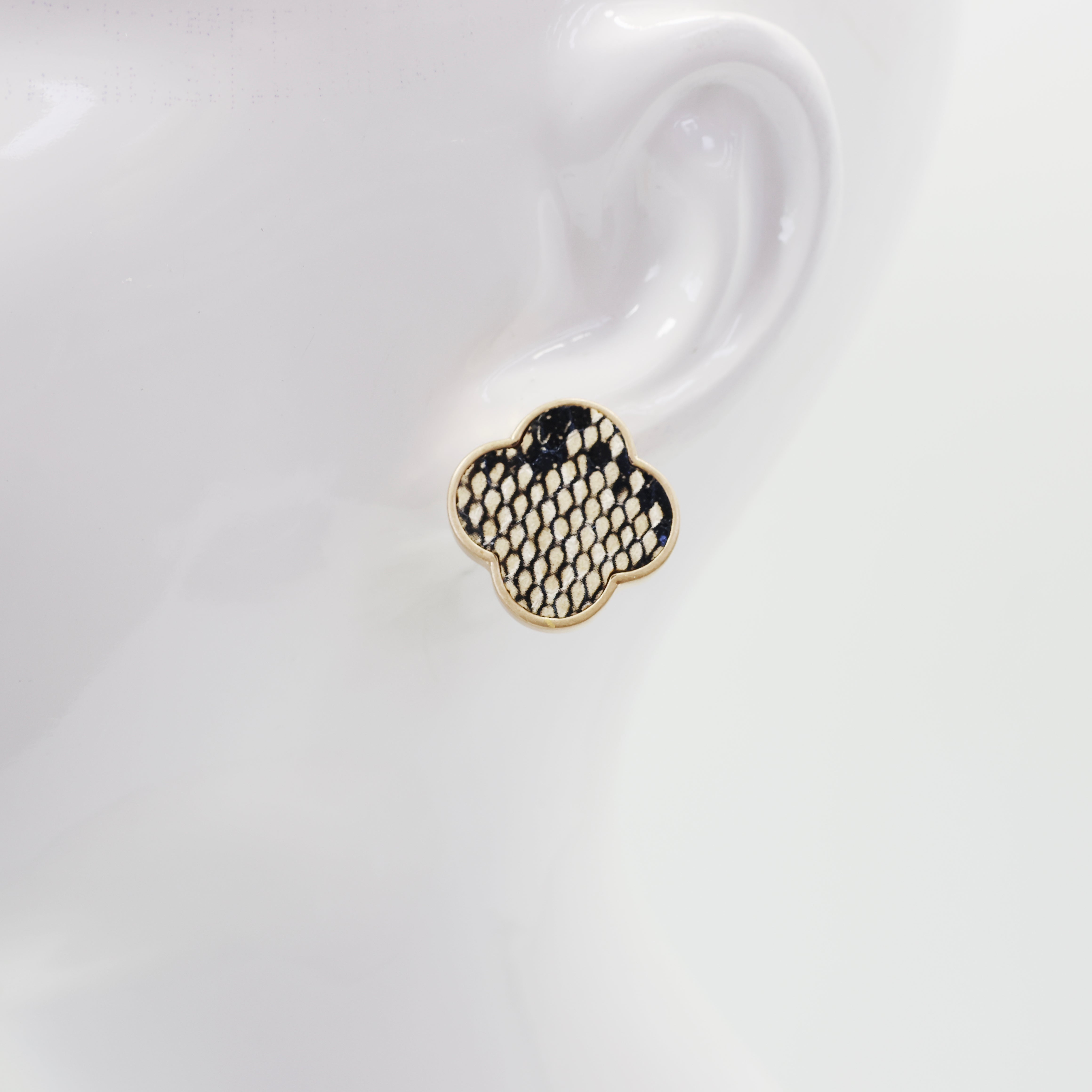 A collection of vintage style earrings with various patterns including floral, geometric, and animal prints.