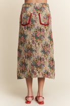 Floral skirt with red pocket details on a beige background
